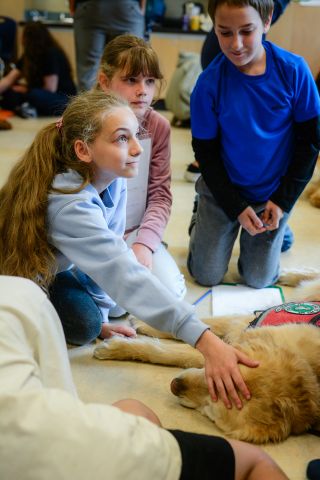 F. L. L. Green Photography; used with permission Students interact with a therapy dog from UBC