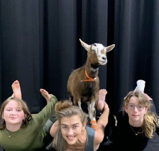 Author, goddaughter, and friend with goat
