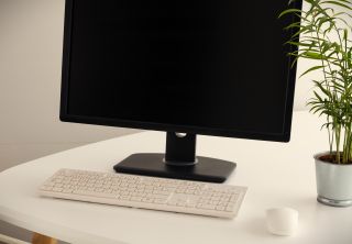 Ramon Lopez / Adobe Stock A photograph of a keyboard and mouse in front of a dormant monitor.