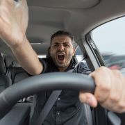 Angry man yelling while driving a car
