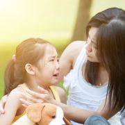 Crying child with mother in park