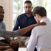 Man getting help from a support group. fizkes/Shutterstock