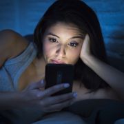 Woman using phone late at night. Marcos Mesa Sam Wordley/Shutterstock
