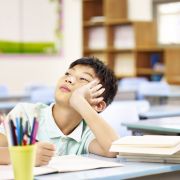 Boy with ADHD distracted during class, struggling with time blindness