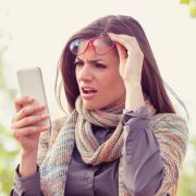 Woman looking at fake news on social media with shocked expression