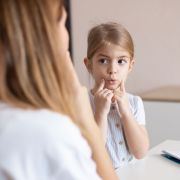 Speech therapist practice therapy for child with motor speech disorders.