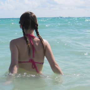 Woman wading into sea