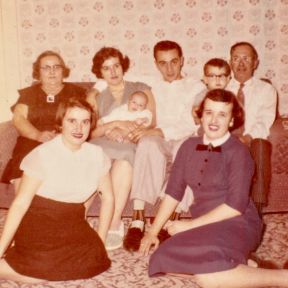 One-month old "Johnny" is welcomed by Mom's family on November 16, 1958, the day of his christening.