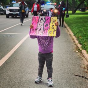 A child holding up a Black Lives Matter sign