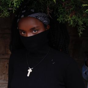 A Black woman wearing a mask