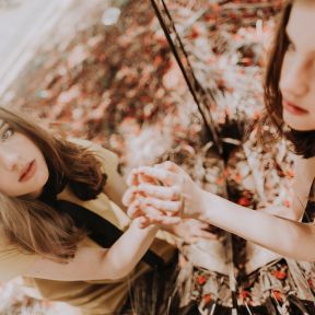 Young woman touching mirror in autumn forest 