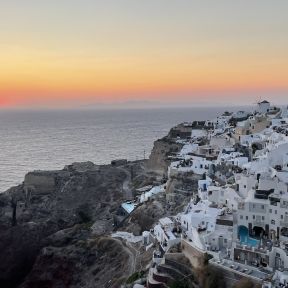 Sun visible beyond Santorini