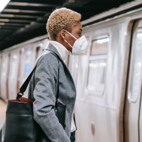 Person wearing a mask entering the subway