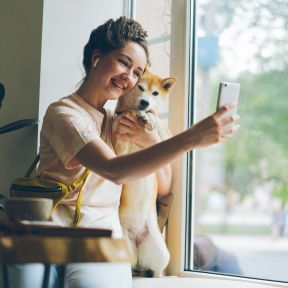 Woman happy with dog and phone