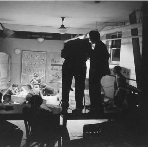 Kurt Lewin and observers watching a group of children in the "project room," in Iowa, 1939