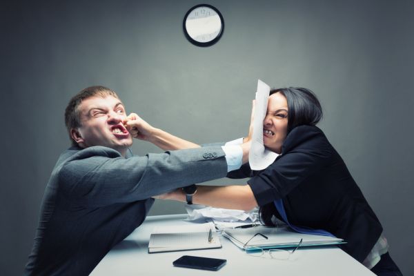 Two business people shoving each other