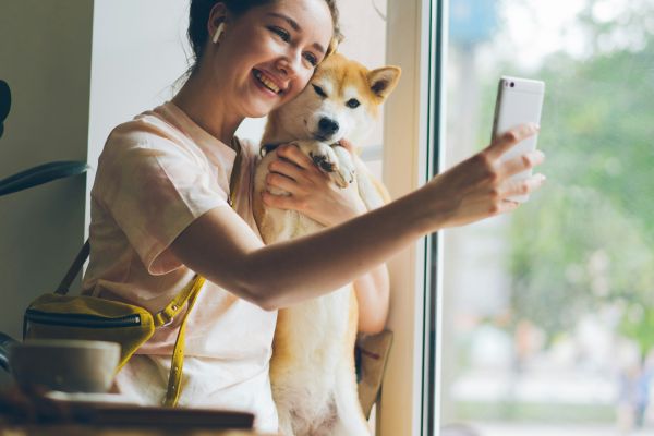 Woman happy with dog and phone