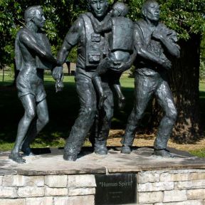 A flood disaster memorial in Fort Collins, Colorado depicting roles for men and women.